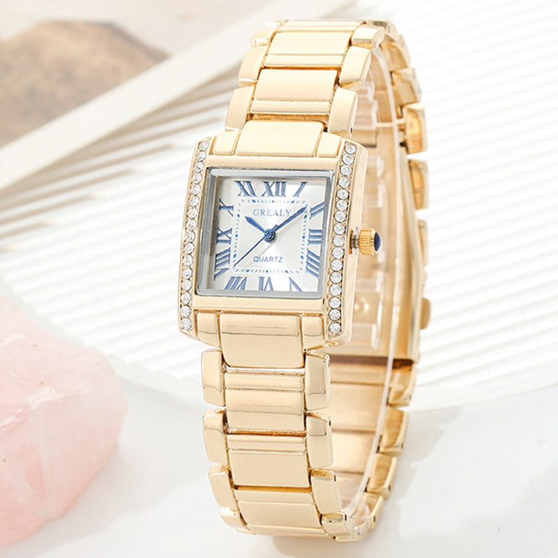 Montre Femme Rectangulaire Avec Chiffres Romains Et Boîtier En Métal Poli Orné De Cristaux Décoratifs