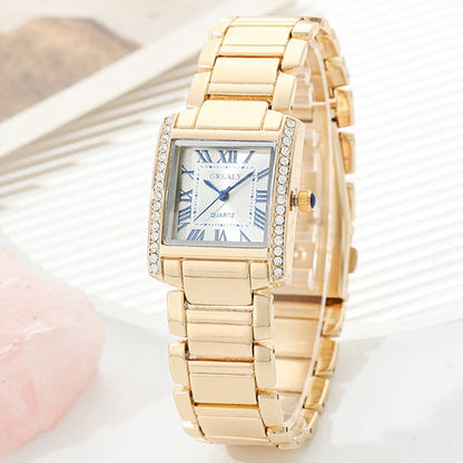 Montre Femme Rectangulaire Avec Chiffres Romains Et Boîtier En Métal Poli Orné De Cristaux Décoratifs