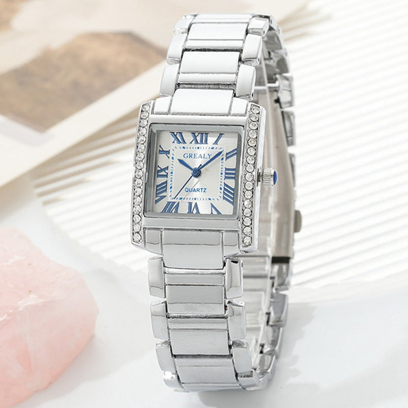 Montre Femme Rectangulaire Avec Chiffres Romains Et Boîtier En Métal Poli Orné De Cristaux Décoratifs
